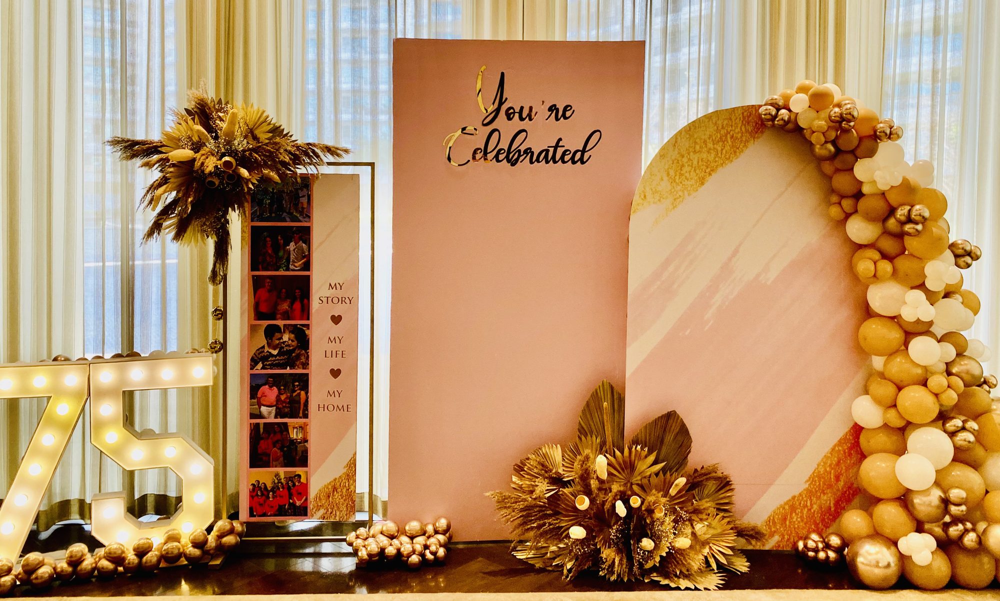 75th milestone "You're Celebrated" gold and pink arch