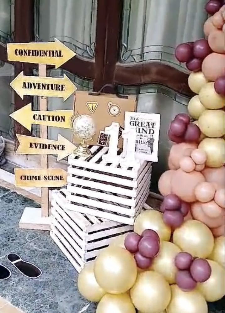 Detective-themed birthday balloon crate signage