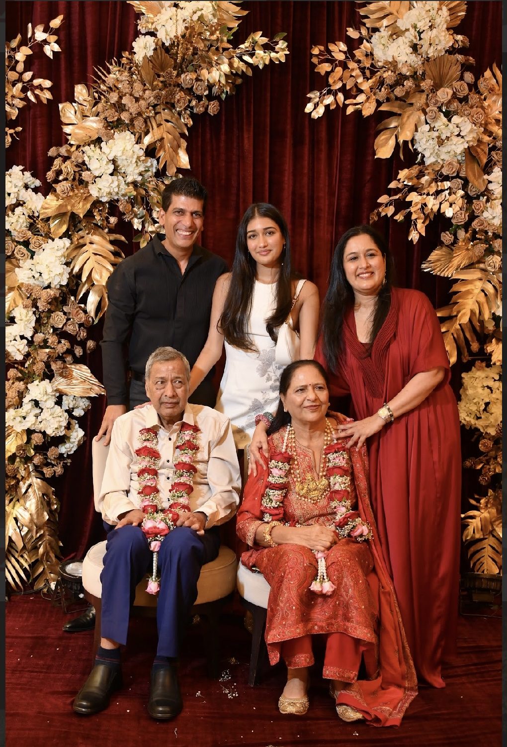 Family group portrait with floral backdrop