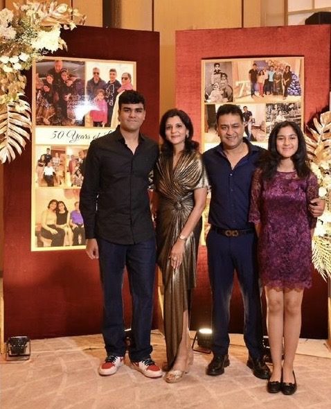 Group photo in front of anniversary backdrop