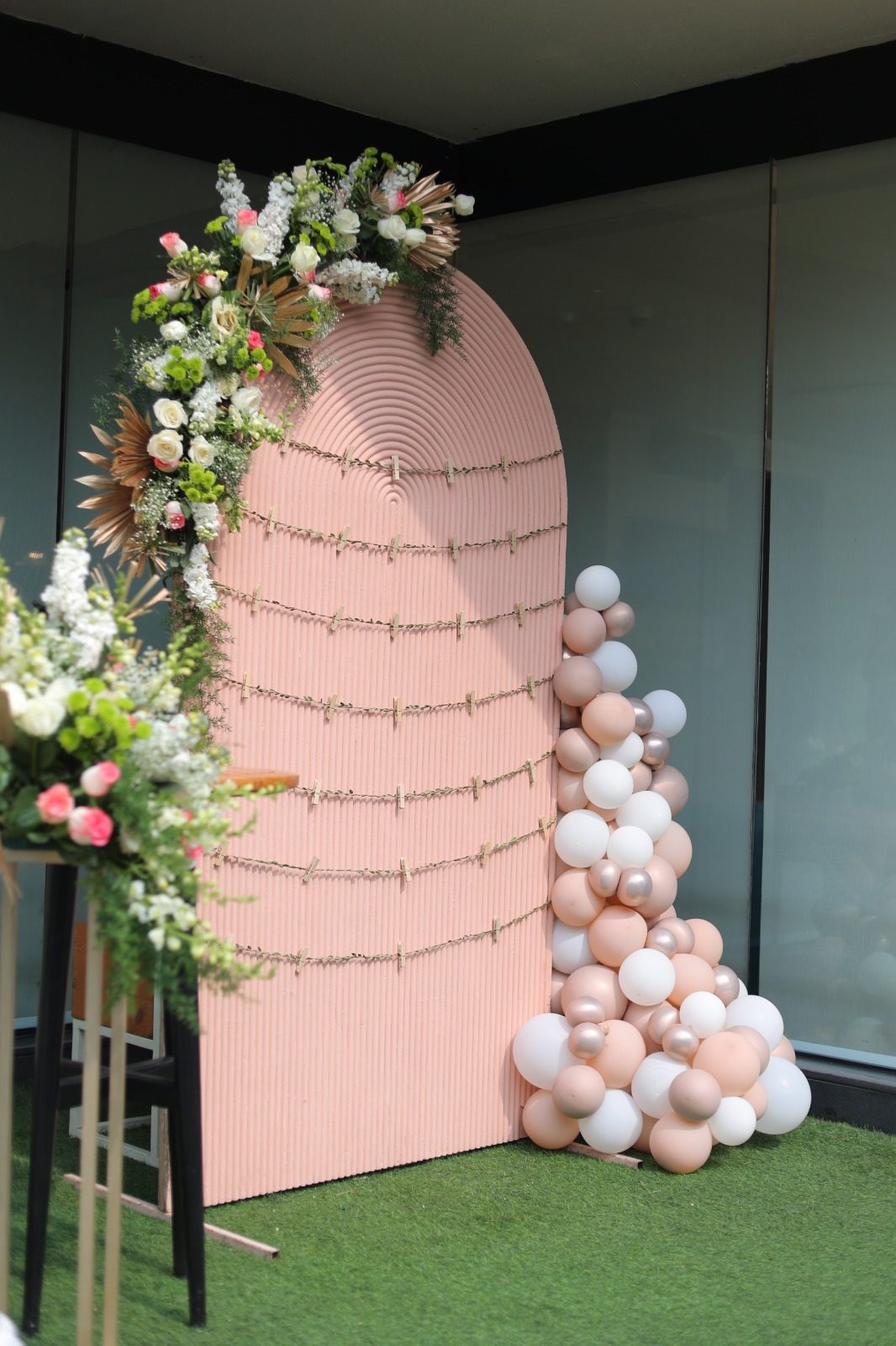 Blush floral arch with balloon garland