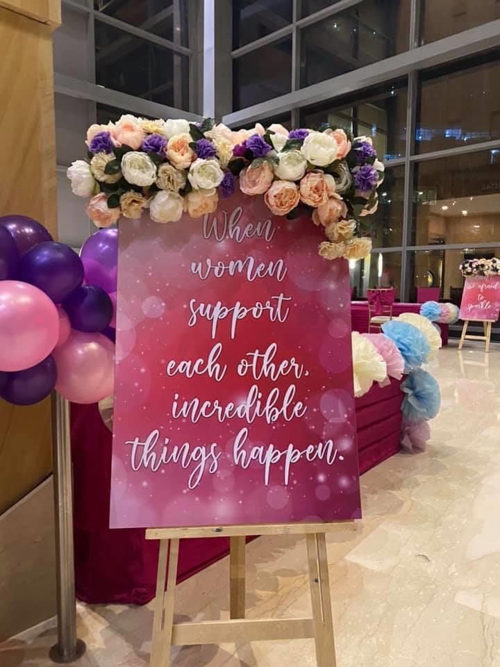 "When women support each other" floral signage