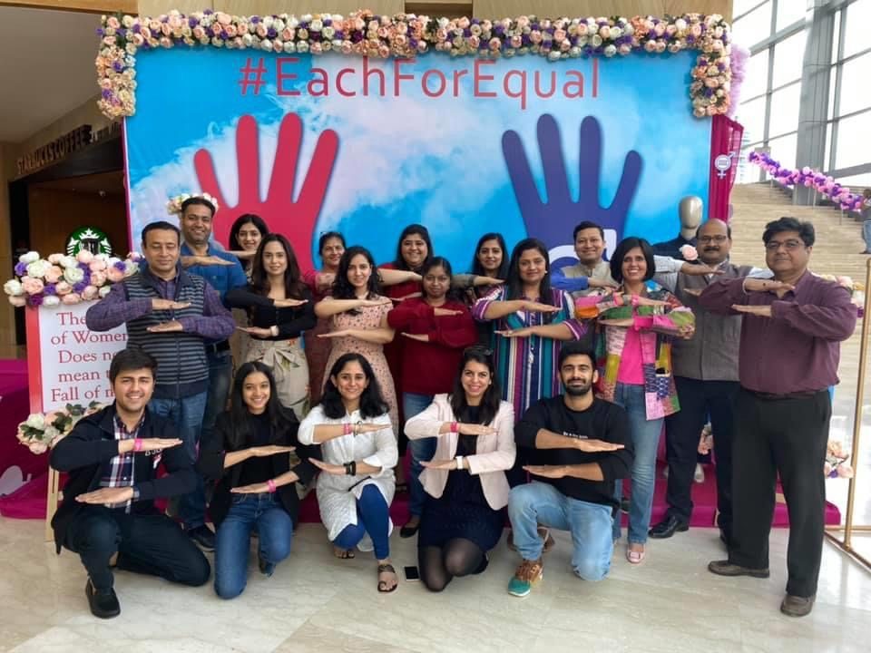 Team group photo with campaign backdrop