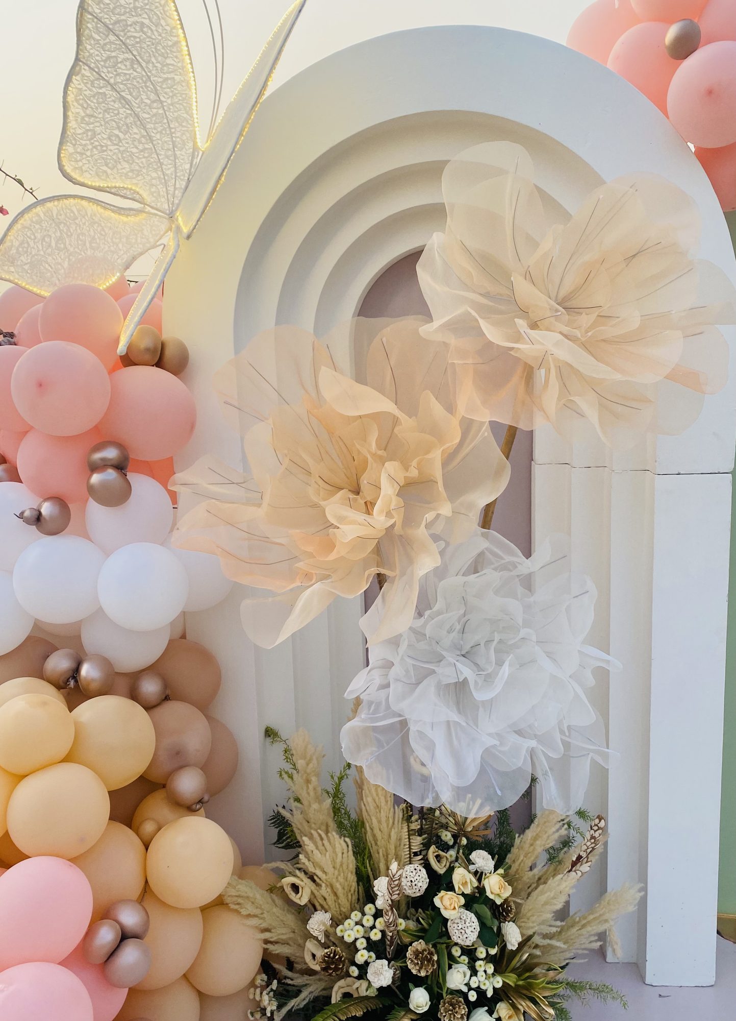 Pink and ivory floral arch with balloon garland