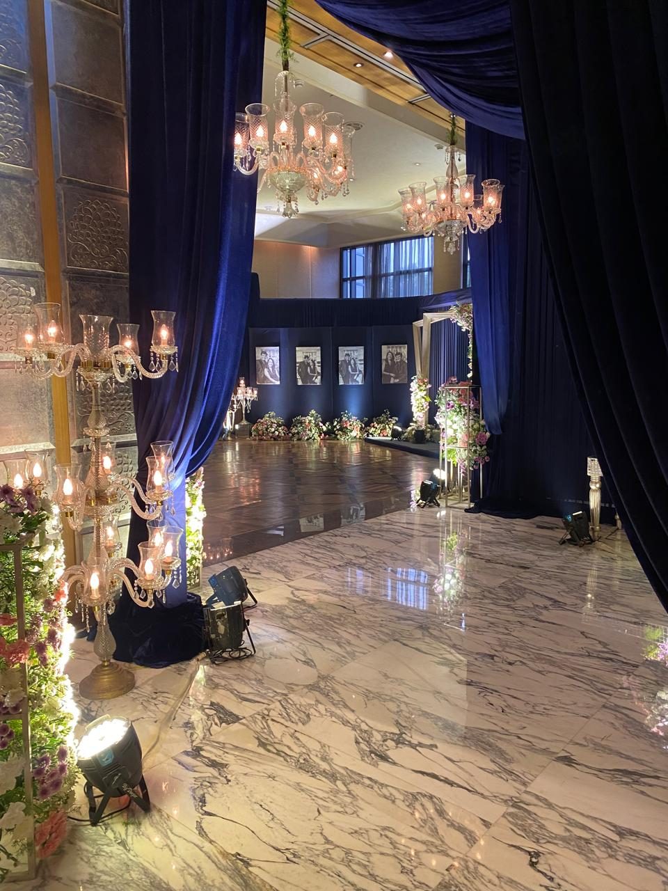 Navy draped reception hall with crystal candelabras