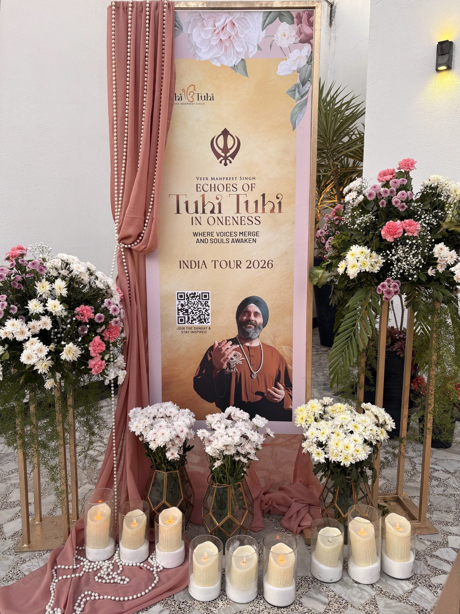 Candlelit floral display with drapery