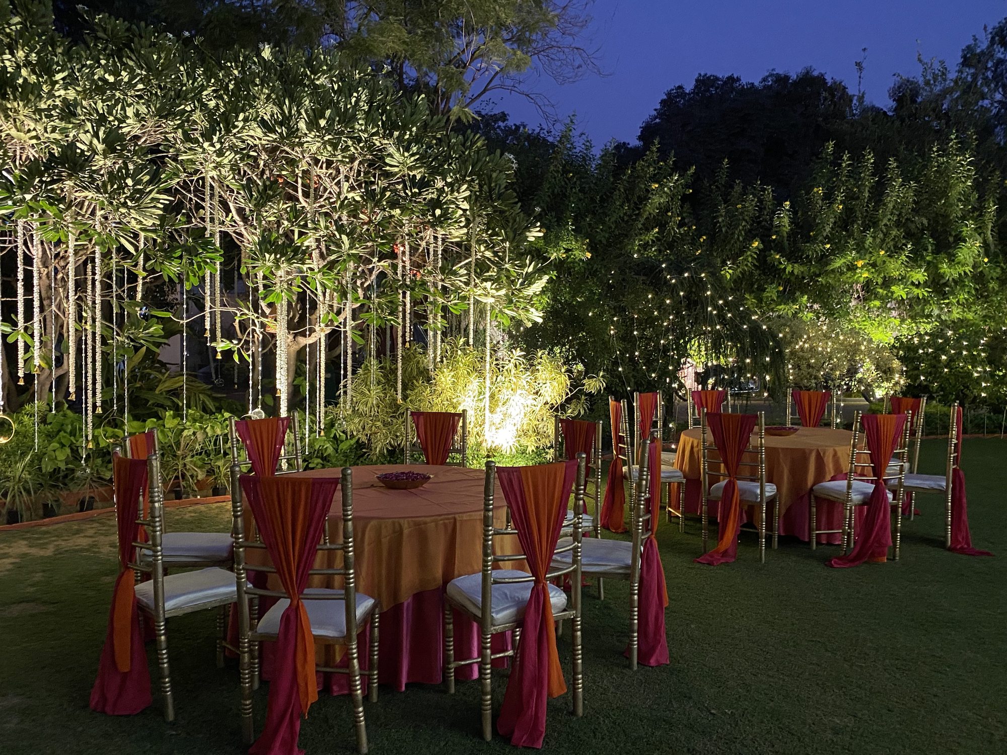 Fairy-lit tree canopy with dining setup