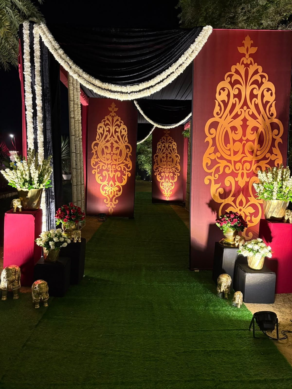 Maroon and gold entrance walkway with gold elephant accents