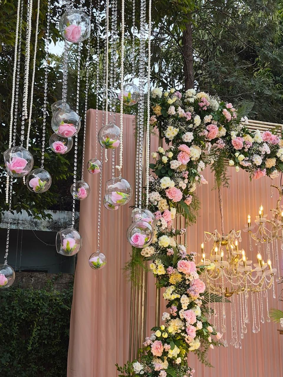 Pink hanging floral backdrop with chandelier