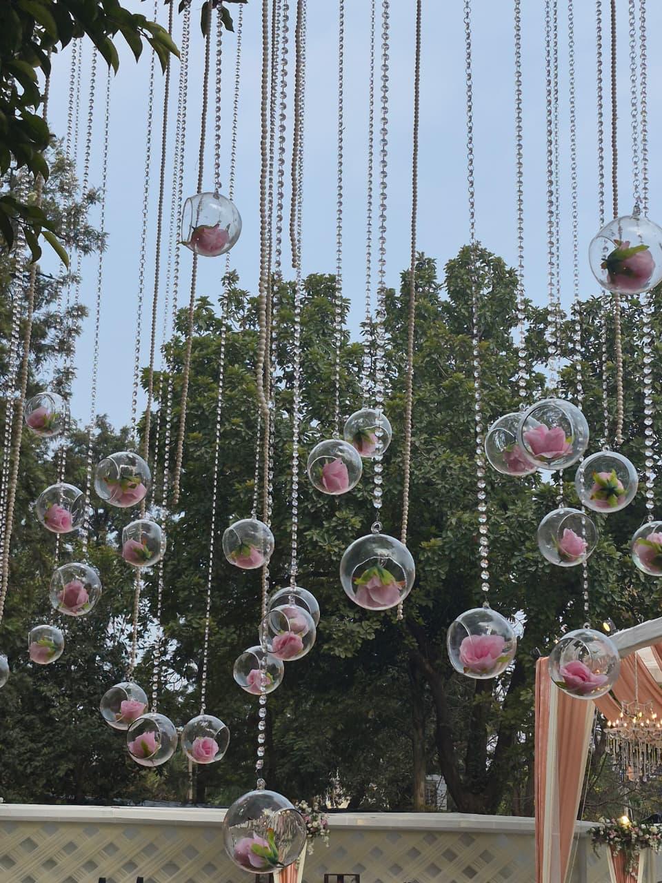 Hanging glass baubles with florals in the trees