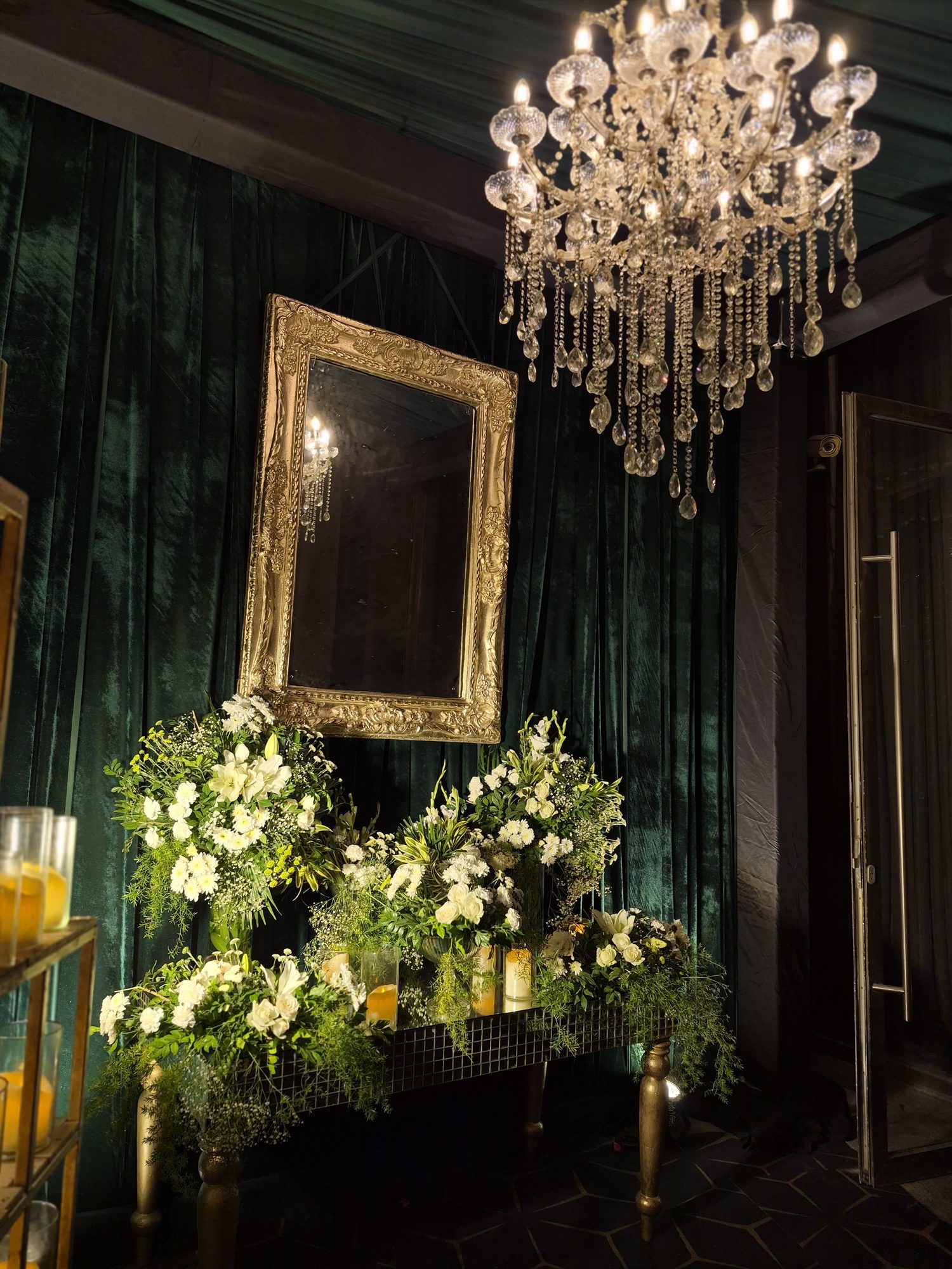 Elegant mirror and chandelier vignette
