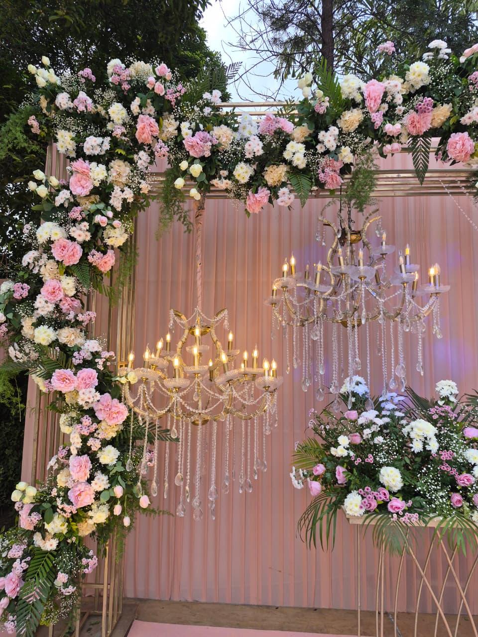 Floral wedding arch with chandeliers